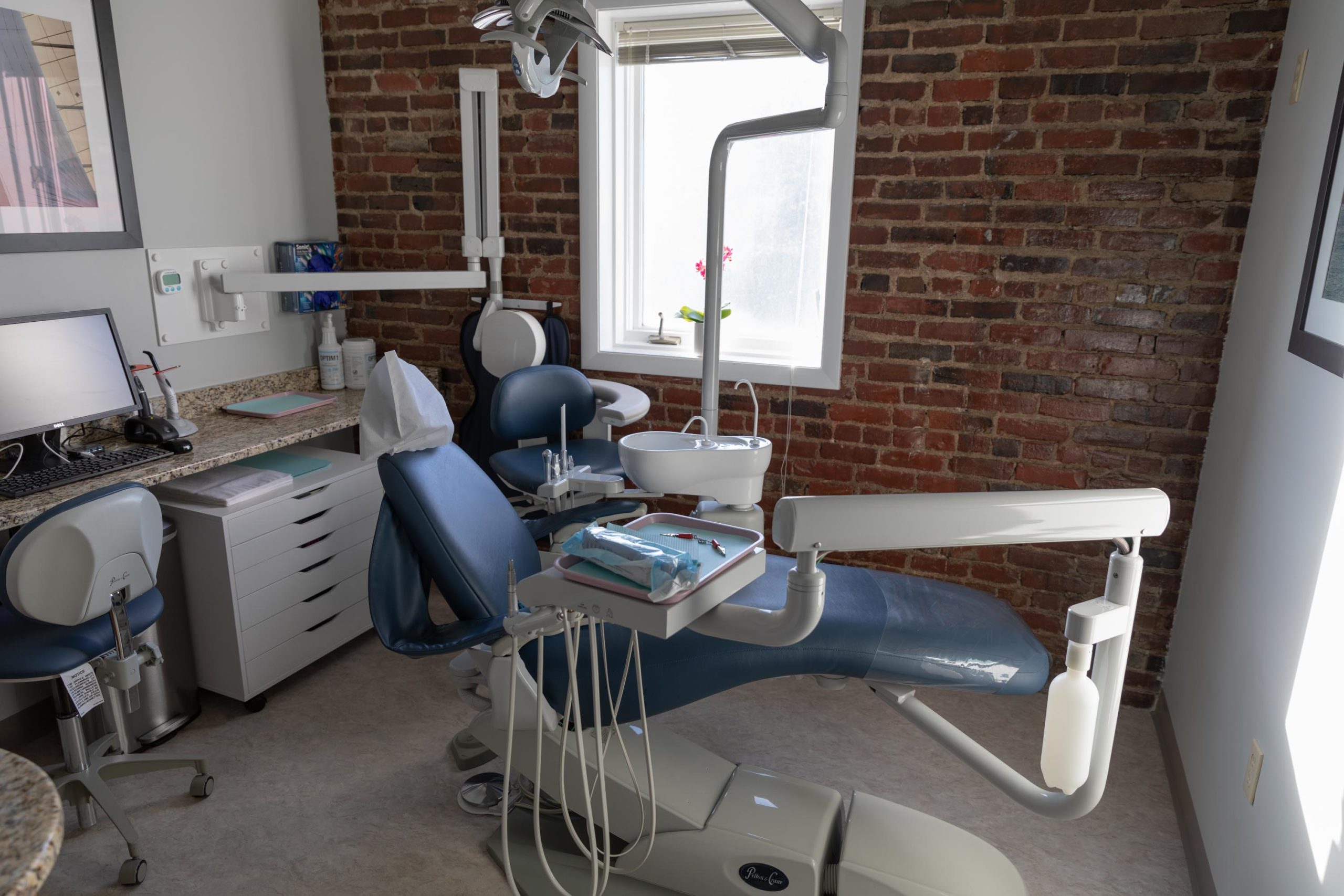 Treatment room with exposed brick at The Dental Specialists