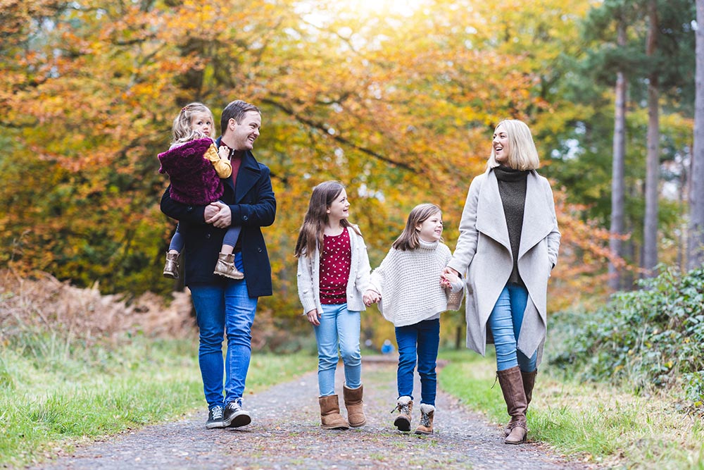 Family walking through autumn woods