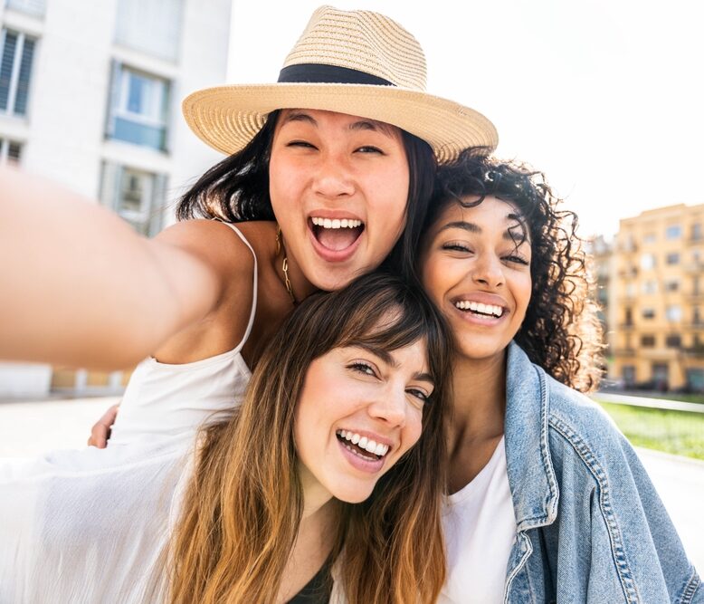 Three smiling people taking a selfie