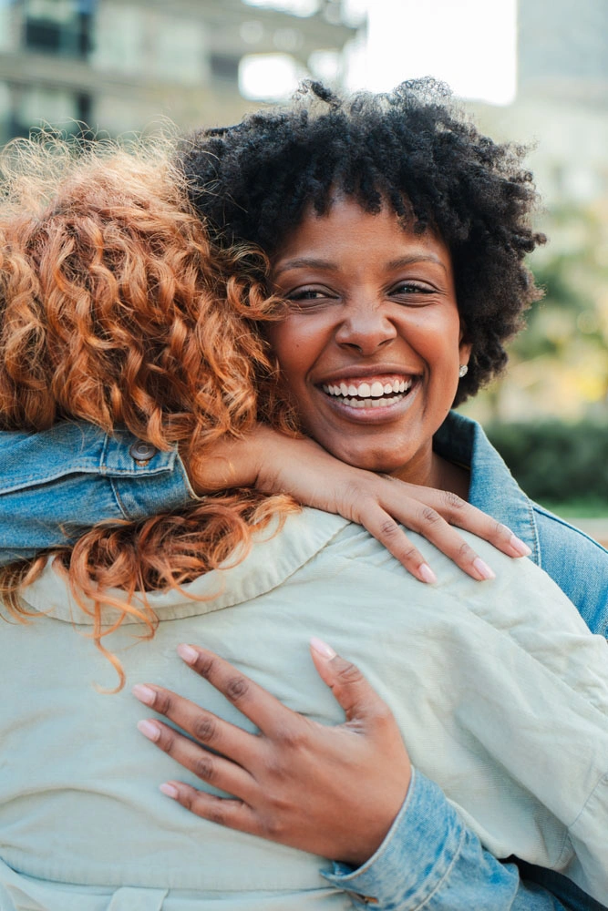 Smiling patient hugging a loved one
