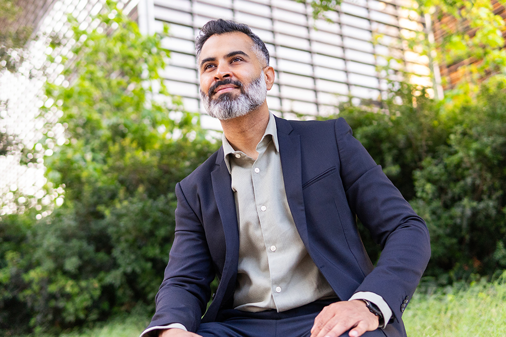 Professional seated in a green city setting